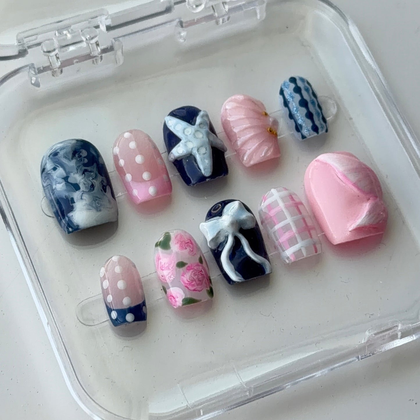 Romantic luxe set featuring hand-sculpted bows, hand-painted florals, plaid detailing, and vintage-inspired mixed nail art